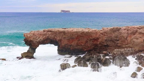 Waves hit stone arch, the beautiful natural rock formations at Malta's island Stock Footage 99685879