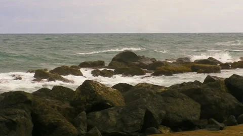 Waves hit waterfront rocks Stock Footage 8519821