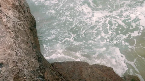 Waves hitting against the rocks at the beach Video stock 131251863