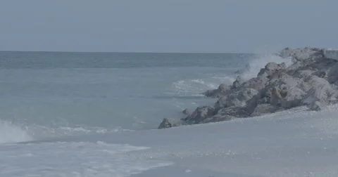 Waves hitting against a shore of Rocks in Boca Grande, Florida Slow-motion Stock Footage 66246984