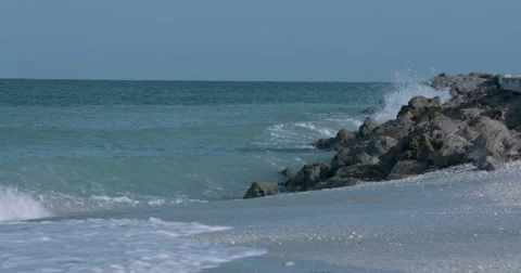 Waves hitting against a shore of Rocks in Boca Grande, Florida Slow-motion Stock Footage 66247726