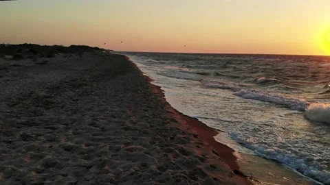 Waves hitting the beach at sunset Stock Footage 138085723