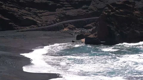 Waves hitting black sand beach, Lanzarote, Canary Islands Stock Footage 168346463