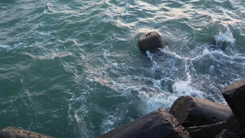 Waves hitting breakwater pier at the Baltic sea Stock Footage 260370906