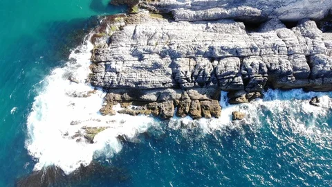 Waves hitting the cliffs on the rocky coast of the sea. Stock Footage 118780488