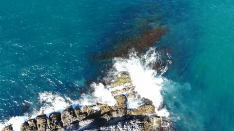 Waves hitting the cliffs on the rocky coast of the sea Stock Footage 139837874
