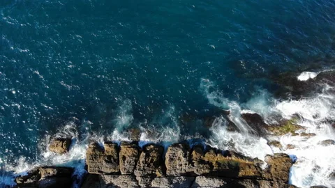 Waves hitting the cliffs on the rocky coast of the sea. Cliffs and sea Stock Footage 139840030