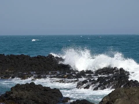 Waves hitting the coast side Stock Photos