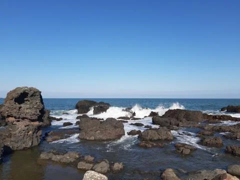 Waves hitting the coast side Stock Photos
