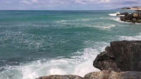 Waves hitting the coastal rocks Stock Footage 64345597