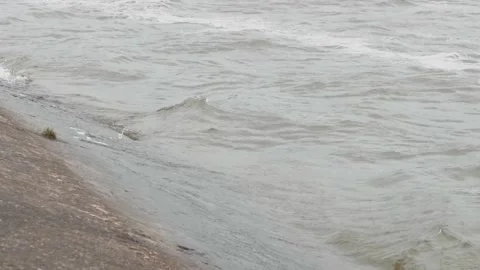 Waves hitting the concrete shore in cloudy weather Stock Footage 162952790