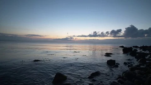 Waves hitting dark rocks at the coast, after sunset Stock Footage 81104869