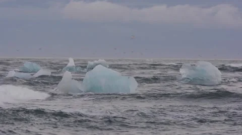 Waves hitting ice blocks near the Ice lagoon, Jökulsárlón, Iceland Stock Footage 40875209