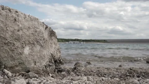 Waves hitting large rock Stock Footage 157283853