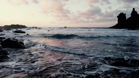 Waves hitting ocean shore on sunset Video stock 122341898