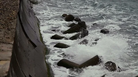 WAVES HITTING THE PIER AND BREAKWATERS, CLOUDY, AUTUMN, RAIN Stock Footage 114632794