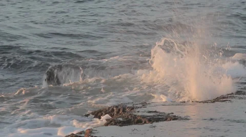 Waves hitting rock during the golden hour before sunset Stock Footage 34094161