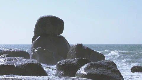 Waves hitting on a rock in super slow motion 100fps Stock Footage 73232671