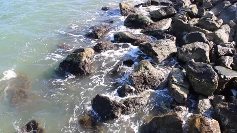 Waves hitting rocks on the beach Stock Footage 136097469