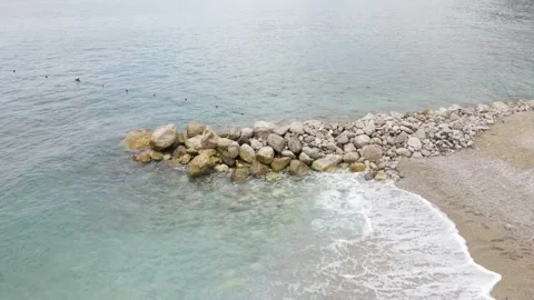 Waves hitting rocks on the beach Stock Footage 163339345