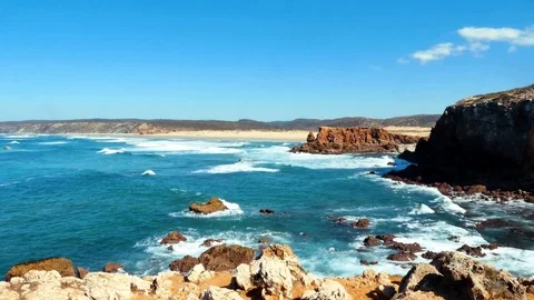 Waves hitting the rocks, Carrapateira, background: Praia da Bordeira, Portugal Stock Footage 87327240