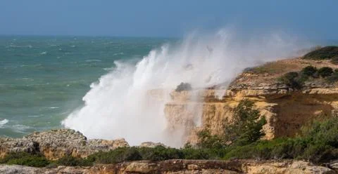 Waves hitting rocks on coast Stock Photos