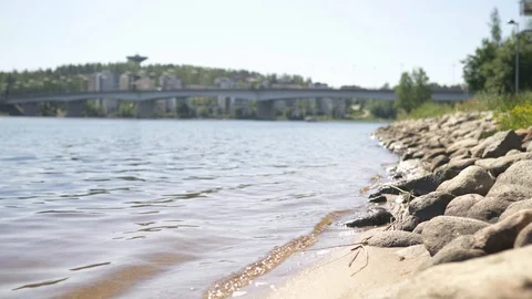 Waves hitting rocks in Jyvaskyla, Finland. Lake and the bridge of Kuokkala. Stock Footage 123770226