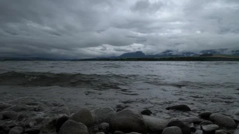 Waves Hitting Rocks with Mountains in the Background at Liptovská Mara Video stock 302029121