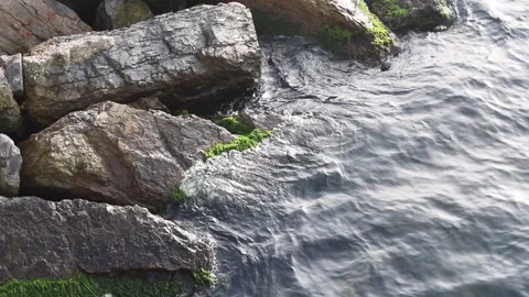 Waves hitting rocks near the shore Stock Footage 149252243