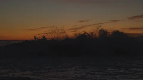 Waves Hitting Rocks in the Pacific Ocean at Sunset Stock Footage 121289215
