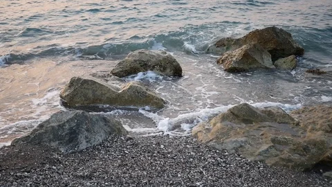 Waves hitting the rocks at sea coast in slow motion Video stock 129838292