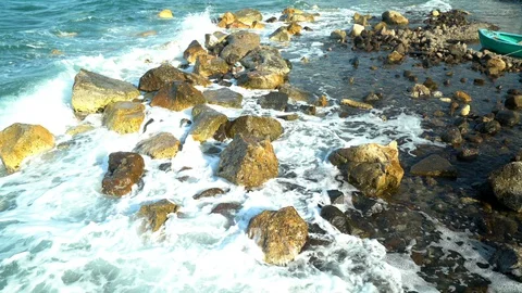 Waves hitting rocks at sea Stock Footage 128458493