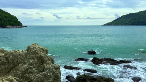 Waves hitting rocks on the shore at Yanui Beach, Phuket, Thailand. Stock Footage 134601230