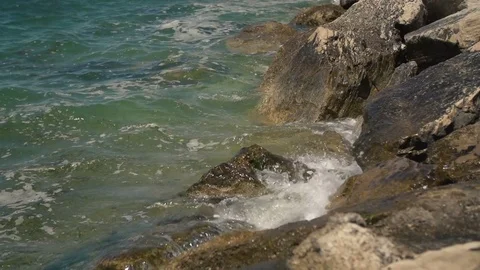 Waves hitting rocks. Slow motion. High definition video. Stock Footage 79581615