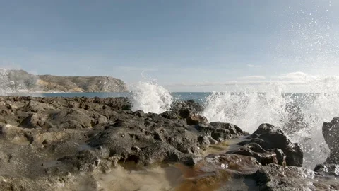 Waves hitting the rocks, in slow motion Stock Footage 149141927