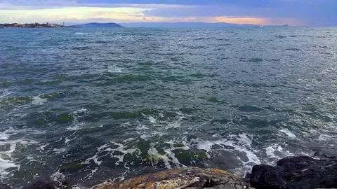 Waves hitting the rocks at sunset Stock Footage 78971955