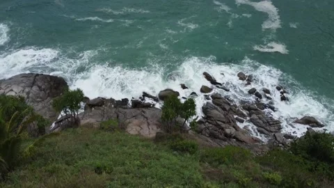 Waves hitting rocks in the tropics, top view Stock Footage 166779941