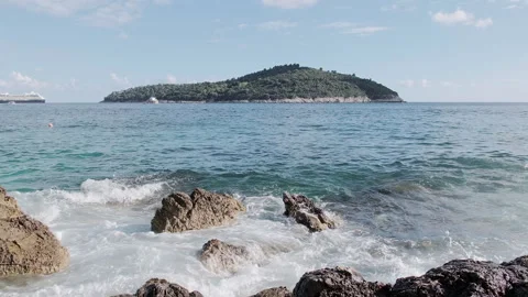 Waves hitting rocks in turquoise waters of Banje Beach, Dubrovnik, Croatia, 4K Video stock 274455378