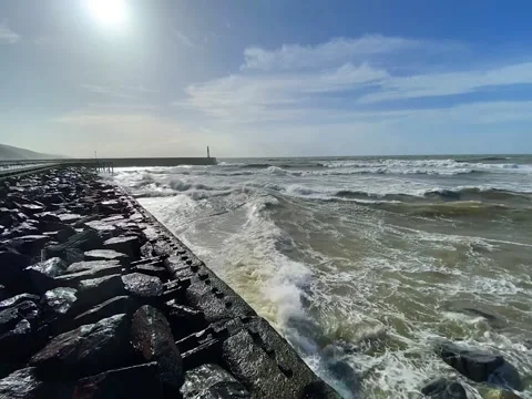 Waves hitting a rocky cliff during windy storm in Aberystwyth, Wales in the UK Stock Footage 166749073