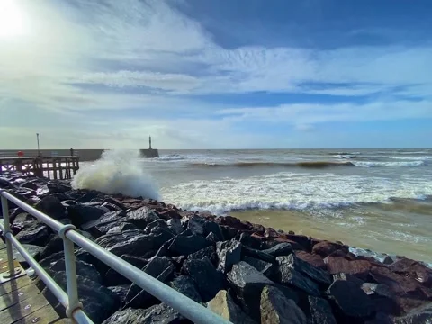 Waves hitting a rocky cliff during windy storm in Aberystwyth, Wales in the UK Stock Footage 166749221
