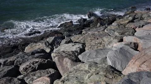 Waves hitting rocky shoreline Stock Footage 331770854