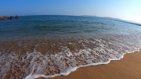Waves hitting a sandy beach in slow motion Stock Footage 111879015
