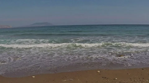 The waves hitting the sandy shore Stock Footage 52979403