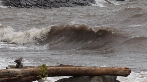 Waves hitting the shore causing shoreline erosion due to high water levels Stock Footage 107755601