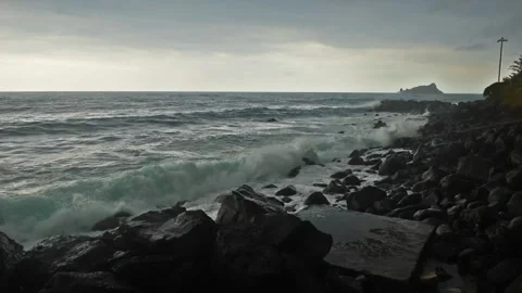 Waves hitting the shore on overcast rainy stormy day. Cyclops Coast, Sicily Vidéo 249270593