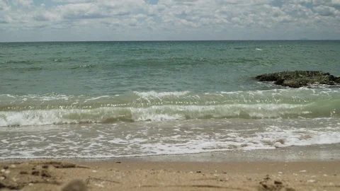 Waves hitting the shore. Soft wave of blue sea on sandy beach. Background Stock Footage 97461050