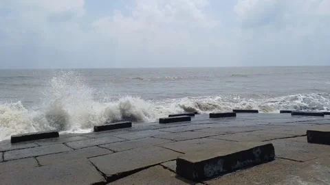 Waves hitting stone blocks in slow motion Stock Footage 272231362