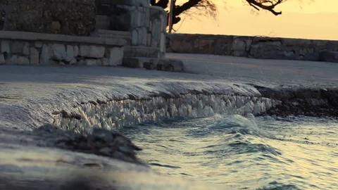 Waves hitting the stone path near the sea. Beach in split, croatia. Early mor Stock Footage 129347183