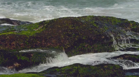 Waves Hitting the Stones in the Beach Stock Footage 32233299