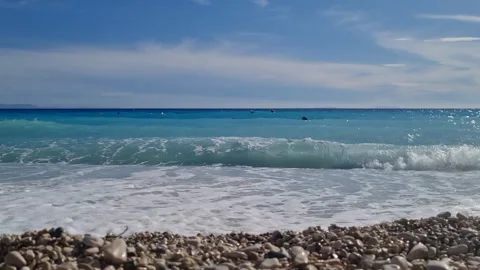 Waves Hitting Stones on the Beach Stock Footage 305844132